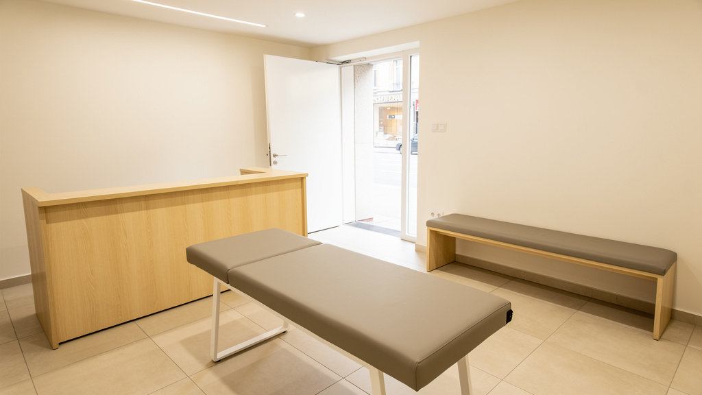 A bright shop entrance with a pale oak reception counter, nobody present